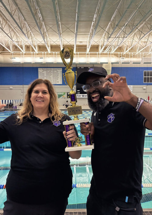 From left to right, head coaches Bruns and Harris put their paws up to showcase Paschal's fierce swim team as they hold up their winning trophy. 